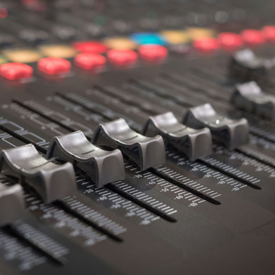 Close-up of audio equipment and headphones in a music studio setting.