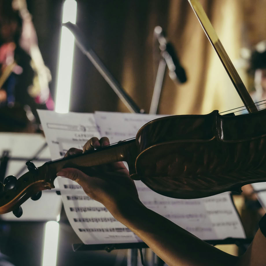 A music producer and artist collaborating in a professional recording studio environment.